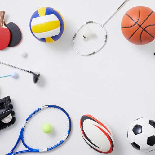 An assortment of sporting goods. A basketball, football, golf club etc